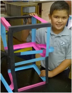 First to complete his marble run, this designer/engineer poses proudly with his creation!
